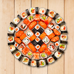 Set of sushi, maki and rolls isolated at wood