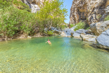 Young pretty girl enjoying the sea at the magnificent Preveli be