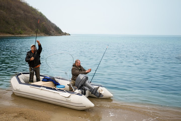 Fishermen on the sea in a boat fishing rods stacked