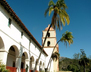 Fototapeta na wymiar Palm trees in front of Old Mission Santa Barbara, California, USA.