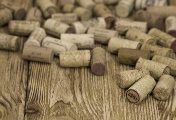 Heap of  used wine corks on the wooden background. Toned image.