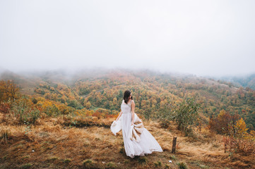 Beautiful bride posing in high mountain scenery