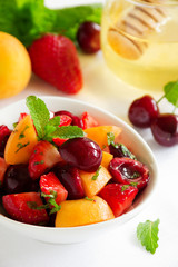 Summer Fruit Salad with strawberries, cherries and peaches in honey dressing.