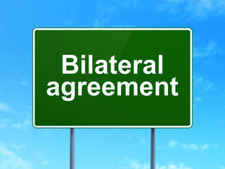 Insurance concept: Bilateral Agreement on road sign background