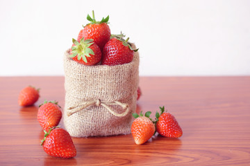 Fresh strawberries in sackcloth bag