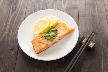 Top view grilled Salmon with lemon on dish