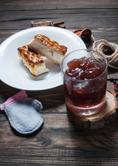 Berry drink. Kissel in glasses with cheese casserole and spices on wood