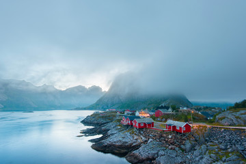 Scenic view of Reine - fishing village with red houses in the morning. Beauty of Hamnoya, Lofoten islands, Norway  - 104364822