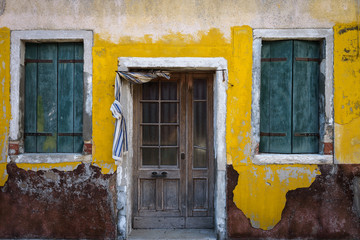 Colorful facades with doors and windows in Burano, Italy.