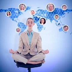 Composite image of peaceful businesswoman sitting in lotus position