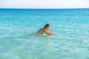 Girl swimming in one of the most beautiful beaches in the world