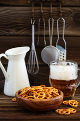 Bretzel pretzels with salt on a wooden background.