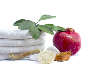 Spa and wellness setting with pomegranate, wooden parts, natural