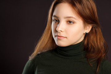 Portrait of redhead woman on dark