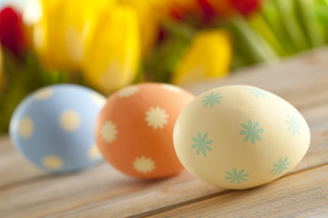 Colorful Easter eggs and fresh tulips