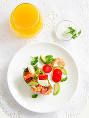 Avocado salad with shrimp and quail eggs.