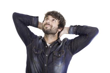 happy handsome young man with his arms behind his head