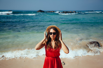 Happy woman enjoying beach relaxing joyful in summer by tropical