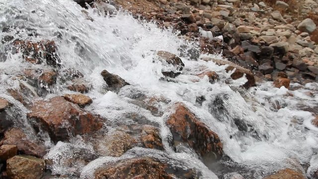 mountain stream rapidly flows among stones