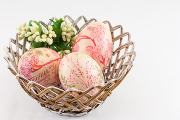 Easter eggs in a basket on white