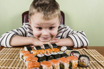 Boy eats a lot of sushi