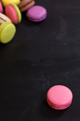 Colorful macaroons on a dark background