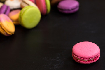 Colorful macaroons on a dark background