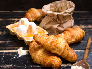 Croissants, flour, eggs, spoon, rolling pin