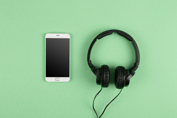  phablet and headphones on the color background