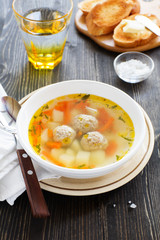 Chicken soup with meatballs.