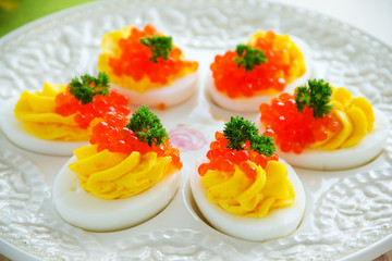 Eggs stuffed with creamy mousse and red caviar.