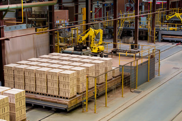 Manufactured bricks stacked on pallets in workshop