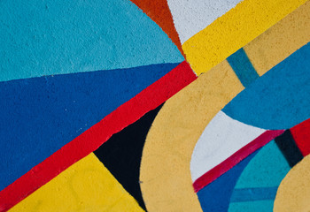Graffiti wall with simple geometric shapes in vivid colors.
