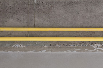 yellow PVC pipes for electrical boxes and wires buried on concre