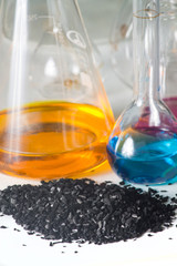 loose coal and glass test tubes with colored liquid