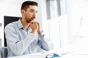 Male office worker sitting at desk