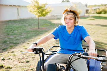 Fototapeta premium Boy riding farm truck in vineyard