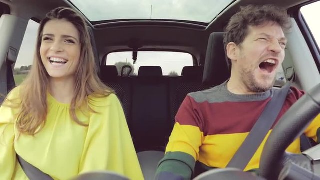 beautiful couple in car driving angry at each other