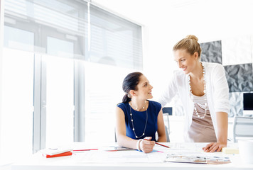 Two female colleagues in office