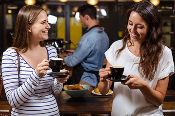 Smiling friends having coffee
