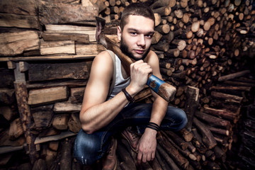 Man with an ax near firewood stock