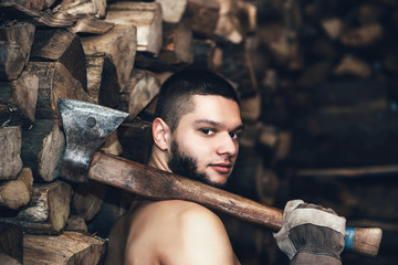 Man with an ax near firewood stock