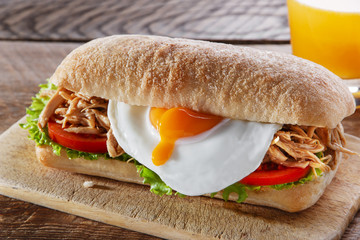 Sandwich with grilled meat egg tomato salad ciabatta