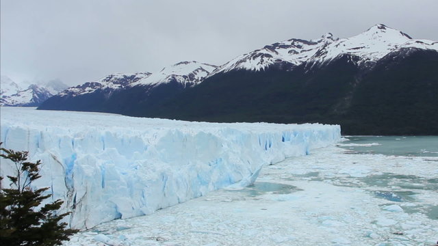 A chunk of a glacier breaks off and falls into the lake. Shot at Perito Moreno Glacier in Patagonia. 