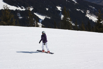 Fototapeta na wymiar Young lady snowboarder. Skiing resort in North Tirol. 