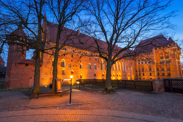 The Castle of the Teutonic Order in Malbork at dusk, Poland