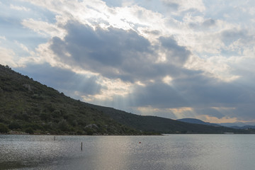 Impressive sunset through the clouds, over the greek sea.