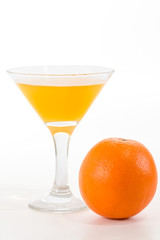 orange juice in a glass and orange on a white background
