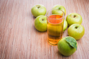 glass of juice and fresh apples