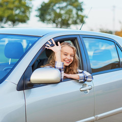 Naklejka premium Young woman driving a car